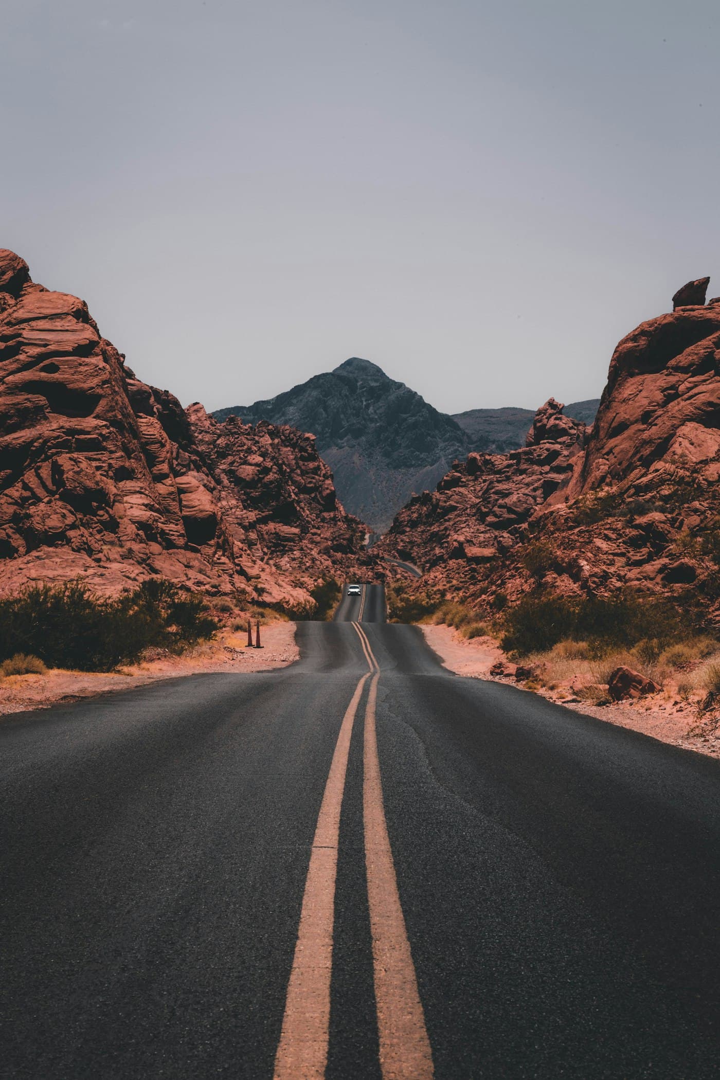 A road stretching through a canyon toward a distant mountain, symbolising purpose, direction, and shared goals